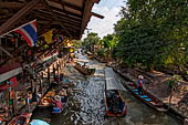 Thailand, Locals sell fruits, food and products at Damnoen Saduak floating market near Bangkok